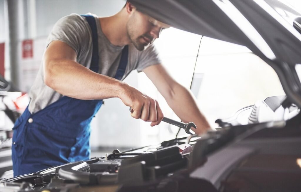 muscular car service worker repairing vehicle 146671 19704